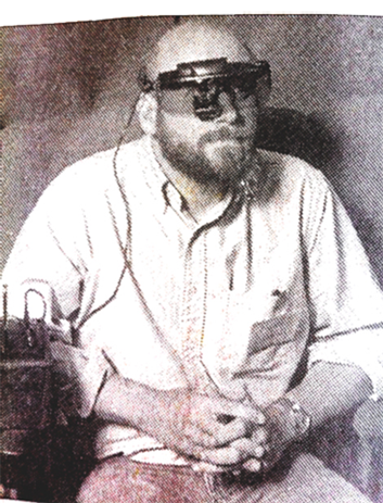 Charles Silverman uses video glasses to see captioned movies in a theatre.